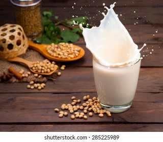 Soy milk splash with beans on wood