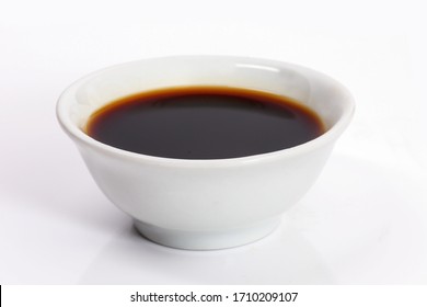 Soy sauce in a bowl isolated on white background