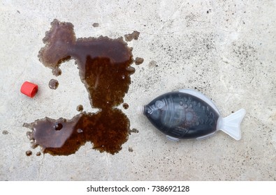 Soy Sauce In Fish Figure Container Spill On Stone Floor