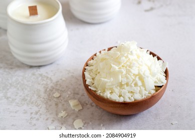 Soy Wax Flakes Ingredient For Homemade Candle Making In Wooden Bowl.