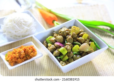 Soya meat served with string hoppers and coconut salad and vegetables on a table