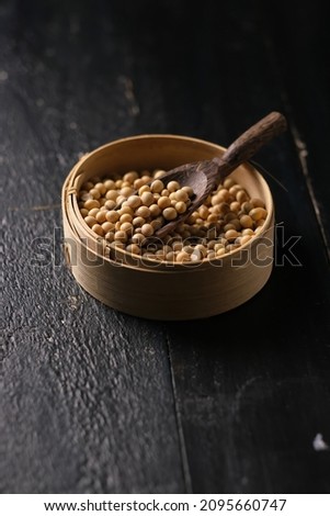 soybean put on bamboo bowl . dark table. Macro photography. Foodphotography. 