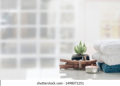 Spa Aromatherapy Concept With Stack Of Clean Towels On White Table Background, Copy Space.