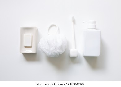 Spa bathroom products. Soap bar, toothbrush, shower ball sponge, shampoo bottle on white background. top view, copy space - Powered by Shutterstock