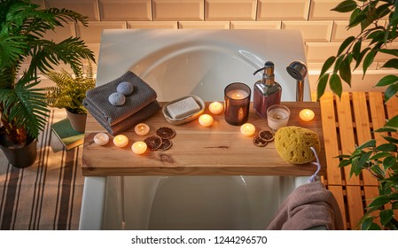 Spa bathtub wooden table vase of plant candle towel brush all kind of spa object. Modern spa center. - Powered by Shutterstock