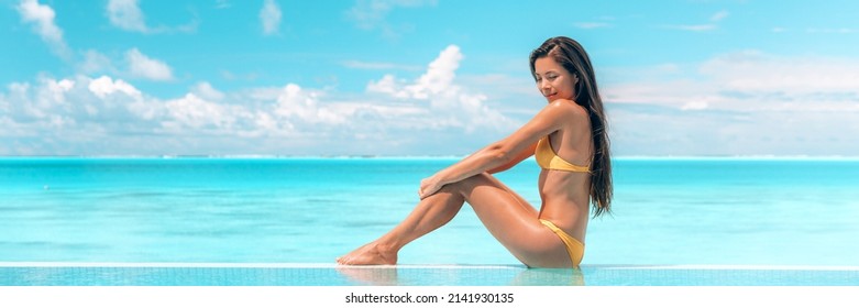 Spa Body Wellness Therapy Asian Beauty Swimsuit Model Woman On Luxury Pampering Pool Resort Relaxing And Sunbathing Doing Sun Tan Skincare. Blue Ocean Sky Background.