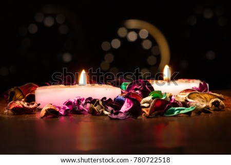 Spa candles and flowers doft light on dark background