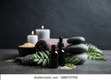 Spa composition with aroma oil on grey table
