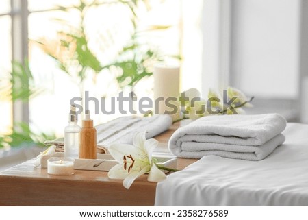 Spa composition with flower on table in salon, closeup