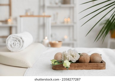 Spa composition with massage balls on couch in salon, closeup