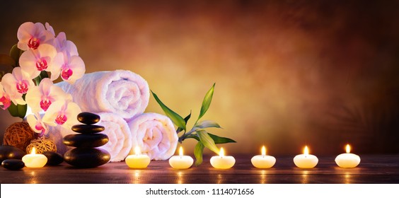 Spa Concept - Massage Stones With Towels And Candles In Natural Background
