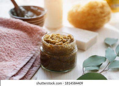 Spa Cosmetic Products, Milk Soap, Handmade Sugar Coffee Scrub With Coconut Oil In Glass Jar And Towel On Wooden Table