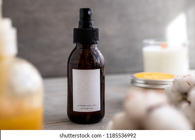 Spa Cosmetics In Brown Glass Bottles With White Label On Gray Concrete Table. Copy Space For Text. Beauty Blogger, Salon Therapy, Branding Mockup, Minimalism Concept