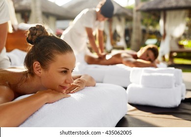 Spa Couple Massage. Beautiful Happy Smiling Woman And Healthy Man Enjoying Relaxing Body Massage Treatment Outdoors At Beauty Salon. People At Romantic Day Spa Resort. Health Care And Relax Concept - Powered by Shutterstock