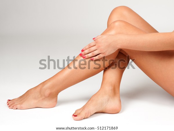 Spa and Epilation. Long woman\
legs after depilation on white background. Skin\
care.\
