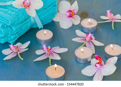 Spa Event With Burning  Candles And Pink  Orchideas