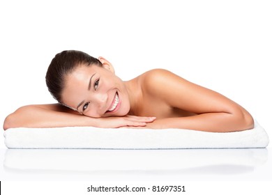 Spa. Face Skincare Beauty Woman Smiling Happy. Beautiful Attractive Mixed Race Chinese Asian / Caucasian Female Model Lying Down On Towel During Skin Care Treatment Isolated On White Background.