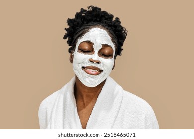 Spa facial mask on African American woman. Skincare and beauty concept with woman wearing a beauty face mask. Clay face mask on a woman. Facial treatment. African American beautiful woman. - Powered by Shutterstock