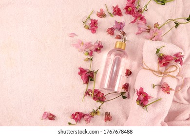 Spa Ingredients With Fragrant Flowers Of Wild Orchids For Skin And Body Care, Rose Water And A Towel On A Bathrobe, Aromatherapy, Lifestyle Concept, Greeting Card For Invitation And Advertising
