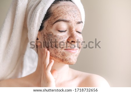 Spa mask at Home, young woman with towel on her head with scrub on her face