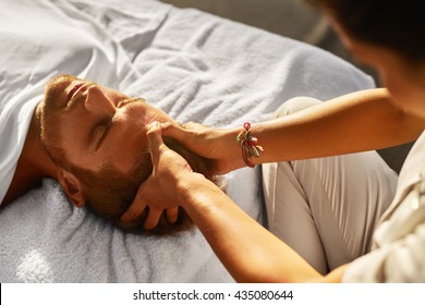 Spa Massage. Closeup Of Beautiful Healthy Happy Man Enjoying Relaxing Head Massage At Outdoor Day Salon. Masseur Hands Massaging Handsome Male Head. Relax Beauty Treatment For Men, Health Care Concept