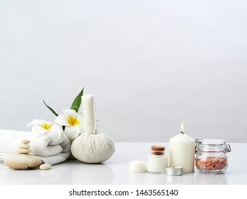 Spa massage concept, herbal compress ball, cream, flower soap, scented candle and Himalayan pink salt, isolated on white - Powered by Shutterstock