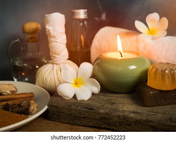 Spa massage items,aroma oil,herbal compress ball,soap  and towel in candlelight.