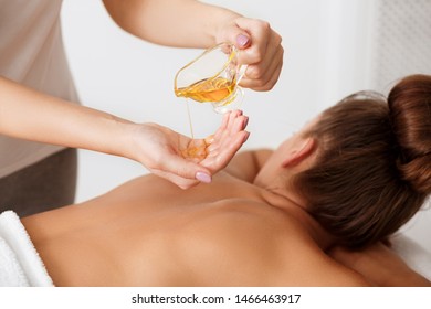 Spa Massage. Masseur Doing Aromatherapy Oil Massage On Woman Body In Spa Salon