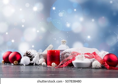 spa massage setting, product, oil and christmas decoration on wooden background, Christmas wellness concept
