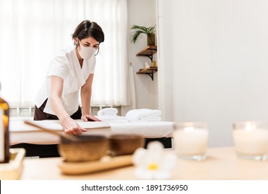 Spa Massage Therapist With Face Mask Working In The New Normal