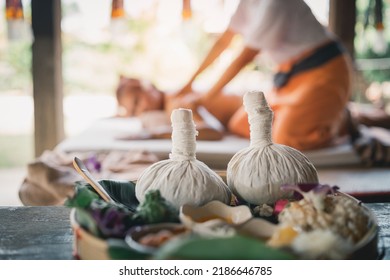 Spa Massage Wellness Decorations Setting On Wood Table. Thai Spa Massage Traditional Compress For Hot Massage And Spa Relaxing Treatment Of Office Syndrome. Massage For Health Concept.