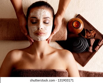 Spa Massage For Young Woman With Facial Mask On Face - Indoors