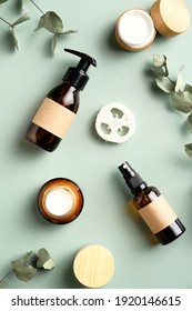 SPA Natural Cosmetics Set On Green Background. Skincare Beauty Products And Eucalyptus Leaves Top View.