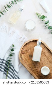 SPA Natural Organic Cosmetics Set 
With Eucalyptus Branches On Stone Table In Bathroom. Flat Lay, Top View.