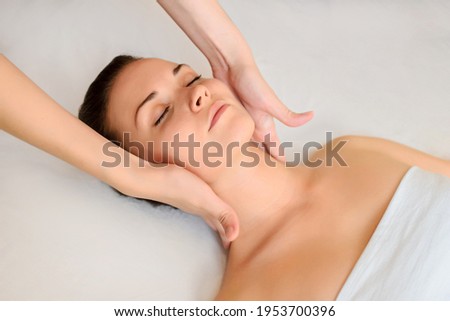 Similar – Young blond woman receiving a head massage