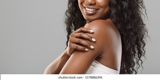 Spa Procedures For Body. Unrecognizable Black Woman Enjoying Her Smooth Soft Skin Over Grey Background, Panorama With Empty Space