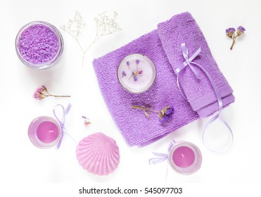 Spa products. Lavender bath salts, dry flowers, soap, cosmetic cream, candles and towel. Violet purple concept. Flat lay on white background, top view. - Powered by Shutterstock