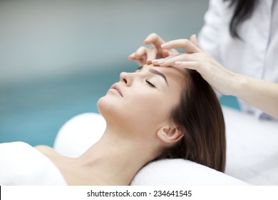 spa, resort, beauty and health concept - beautiful woman in spa salon getting face treatment 