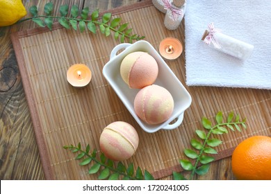 Spa Resort Setting. Still Life Flatlay With Bath Bombs, Salt And Candle On Wooden Background. Spring Or Summer Tropical Concept.