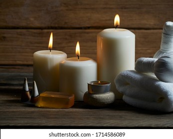 Spa set with alight candles and the smoke of burning frankincense on wooden table. Space for text - Powered by Shutterstock