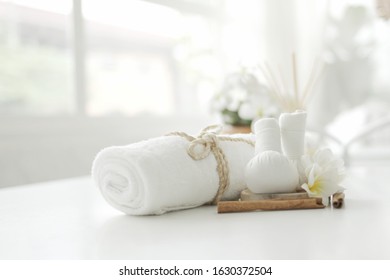 spa set has a hot compress and white fabric roll on the white table. Spa concept