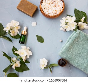 Spa Setting Flatlay With Bath Salt, Jasmine Oil Bottle And Flowers, Towel And Natural Soap. Spa And Wellness Still Life