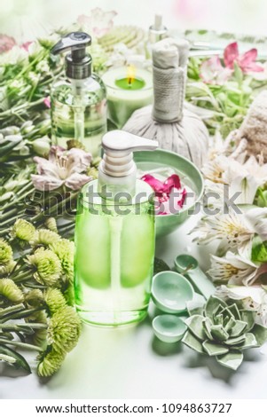 Image, Stock Photo Green cosmetics bottle with flowers and spa accessories