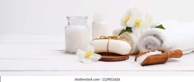 Spa Setting And Health Care Items,jasmin Aromatic Soap,body Oil,bath Salt,milk,massage Stones And Towels, On Wooden Board