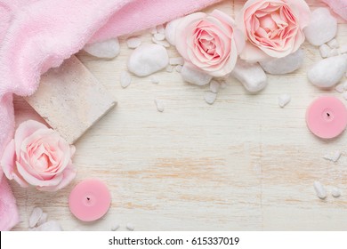 Spa settings with roses. Various items used in spa treatments on white wooden background.