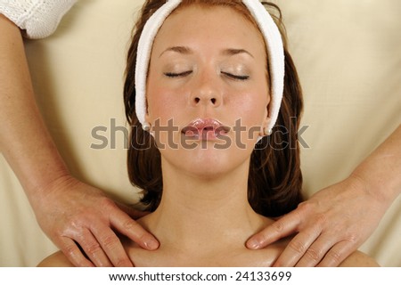 Young blond woman receiving a head massage