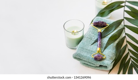 Spa Still Life With Amethyst Roller, Candle, Towel And Green Leaf Plant, Spa And Wellness Setting