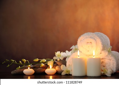 Spa still life with aromatic candles,orchid flower and towel.