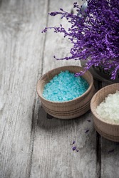 SPA Still Life, Bath Salt Closeup With Violet Flowers On Wooden Background. Desaturated