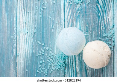 SPA still life, closeup of blue bath bombs on wooden background. Flat lay with space for text